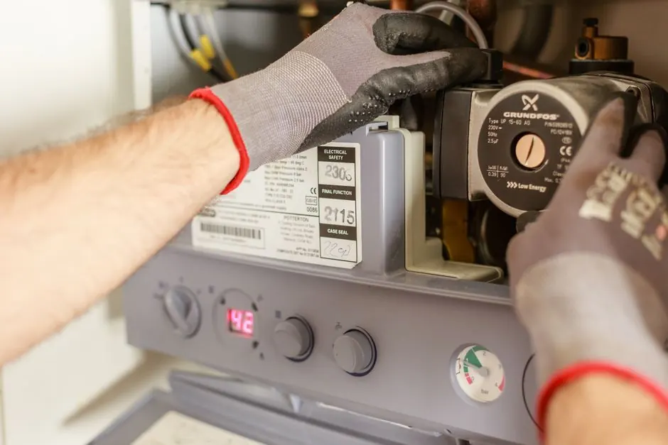 Technician performing pressure test on gas piping with gauges in Georgetown TX