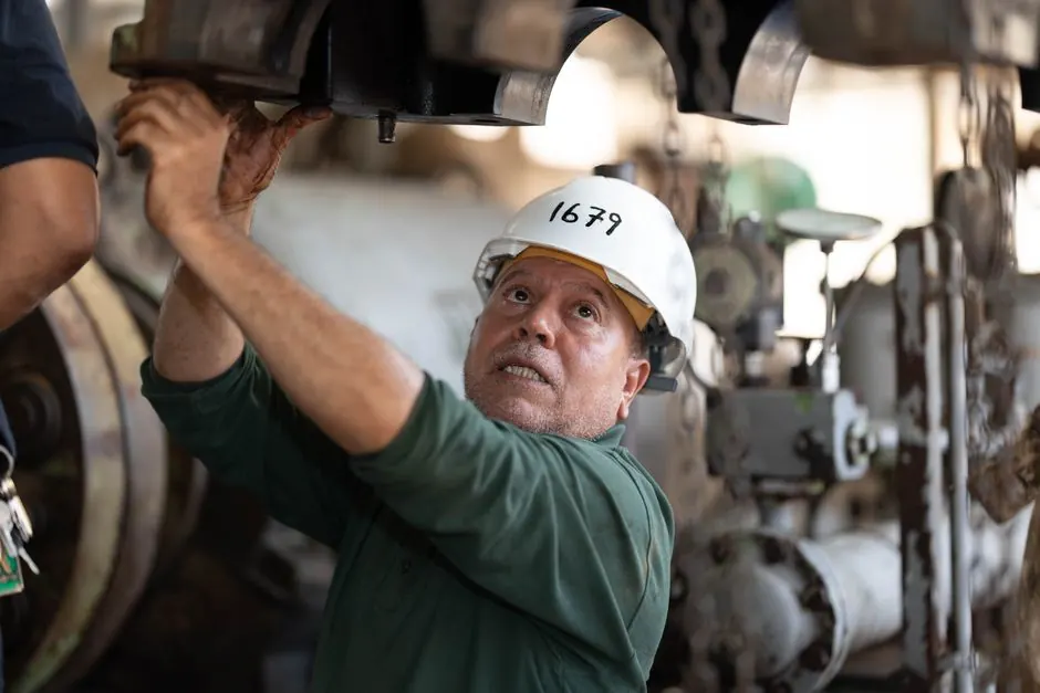 Technician examining commercial gas equipment in a Georgetown TX business facility